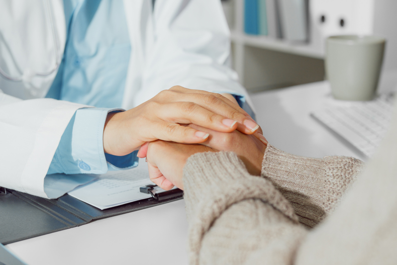 Close up of doctor talking with patient about mental health in health care stock photo