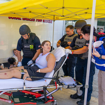 EXERCISE — Coral Gables Fire Rescue prepares to transport a role-player during a full-scale emergency training exercise held at Stanford Residential College on Wednesday, May 22, 2024.