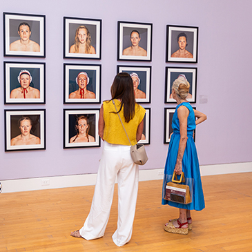 Lowe Art Museum patrons view works on display during the opening reception for “She’s a Knockout,” which features works by 11 contemporary artists from around the world.