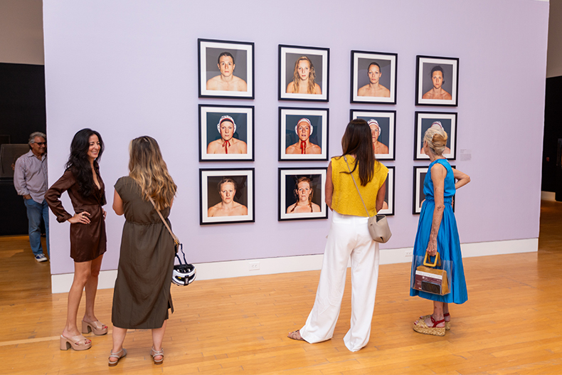 Lowe Art Museum patrons view works on display during the opening reception for “She’s a Knockout,” which features works by 11 contemporary artists from around the world.