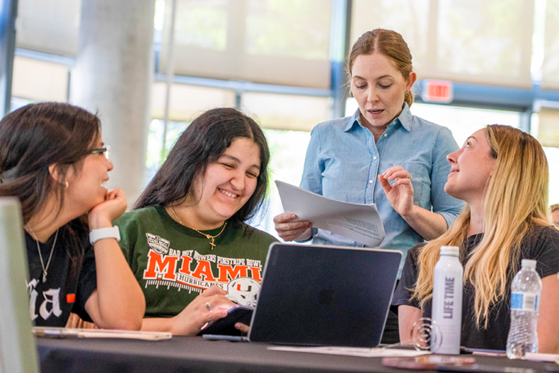 Professor Katlyn Meier reviews Chemistry 102 exam questions with a group of students during the Finish Strong study event held at Lakeside Village.